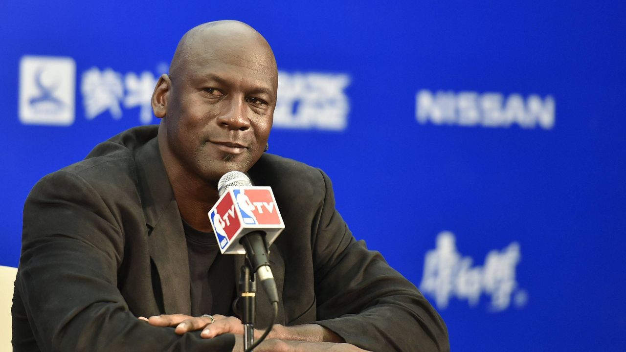 American basketball superstar Michael Jordan, owner and chairman of the Charlotte Hornets, listens at a press conference