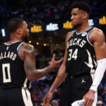 Feb 15, 2024; Memphis, Tennessee, USA; Milwaukee Bucks guard Damian Lillard (0) talks with forward Giannis Antetokounmpo (34) during a time out during the first half against the Memphis Grizzlies at FedExForum.