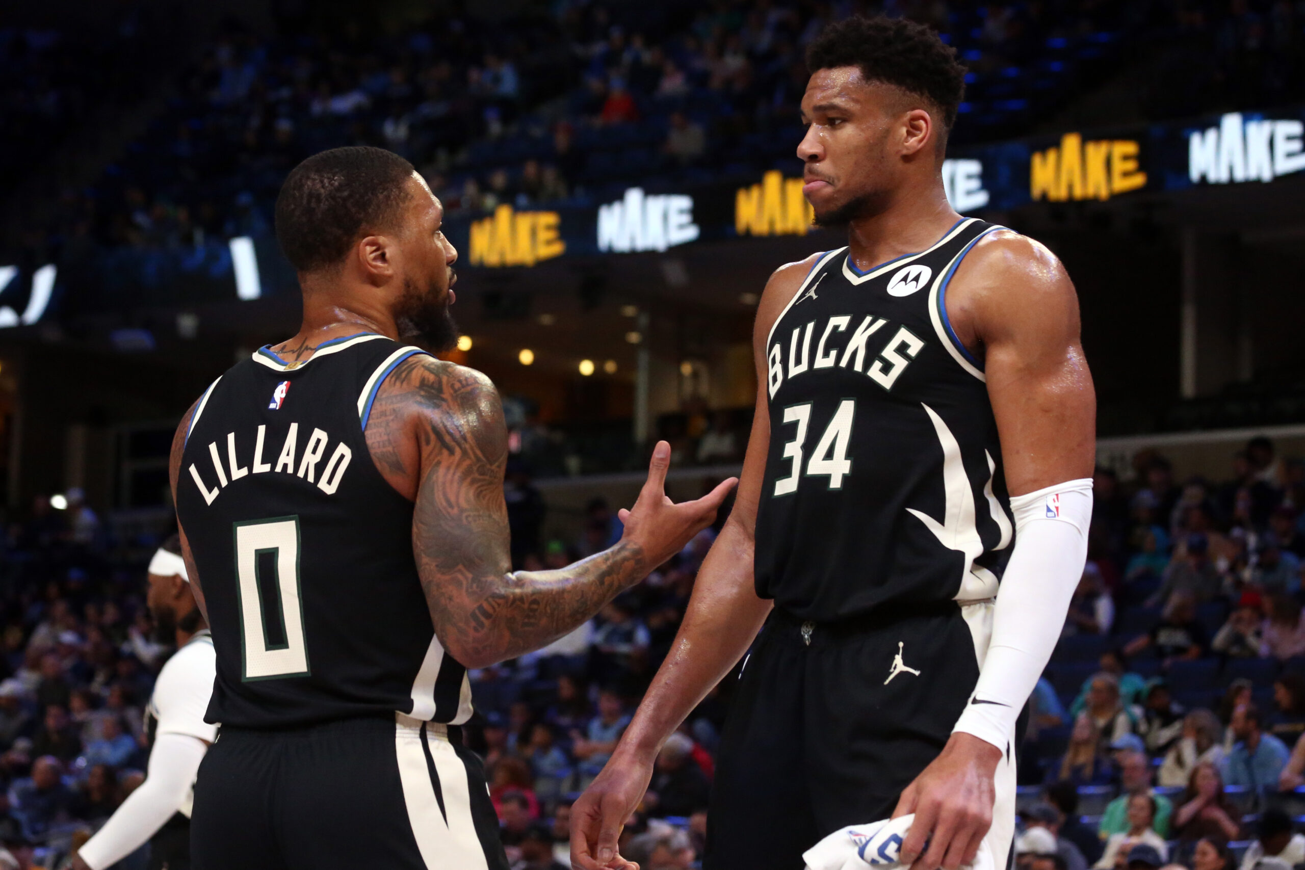 Feb 15, 2024; Memphis, Tennessee, USA; Milwaukee Bucks guard Damian Lillard (0) talks with forward Giannis Antetokounmpo (34) during a time out during the first half against the Memphis Grizzlies at FedExForum.