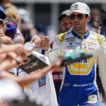 NASCAR Cup Series driver Chase Elliott (9) signs autographs for fans on Sunday, July 27, 2025, ahead of the Brickyard 400 at Indianapolis Motor Speedway.