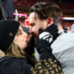 Recording artist Taylor Swift and Kansas City Chiefs tight end Travis Kelce (87) react after the AFC Championship game against the Buffalo Bills