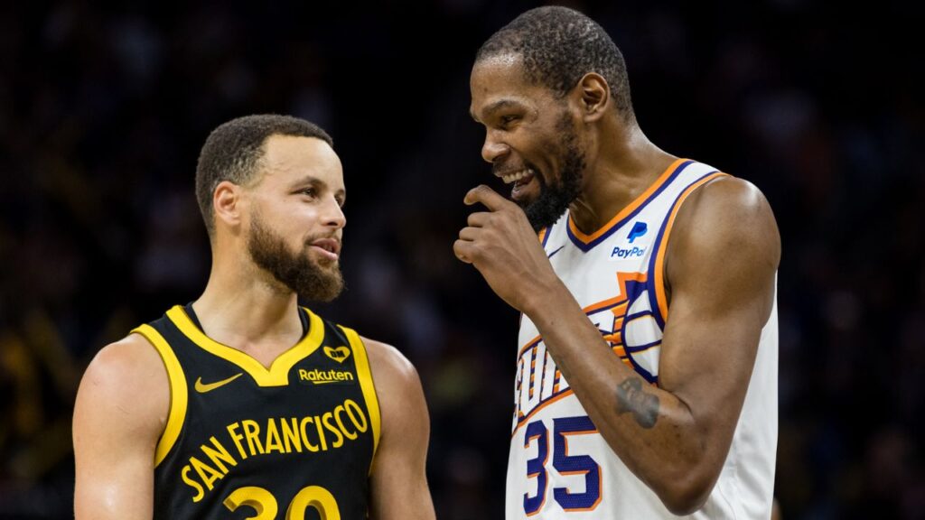 Golden State Warriors guard Stephen Curry (30) and Phoenix Suns forward Kevin Durant (35) talk during the second half at Chase Center.