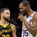 Golden State Warriors guard Stephen Curry (30) and Phoenix Suns forward Kevin Durant (35) talk during the second half at Chase Center.