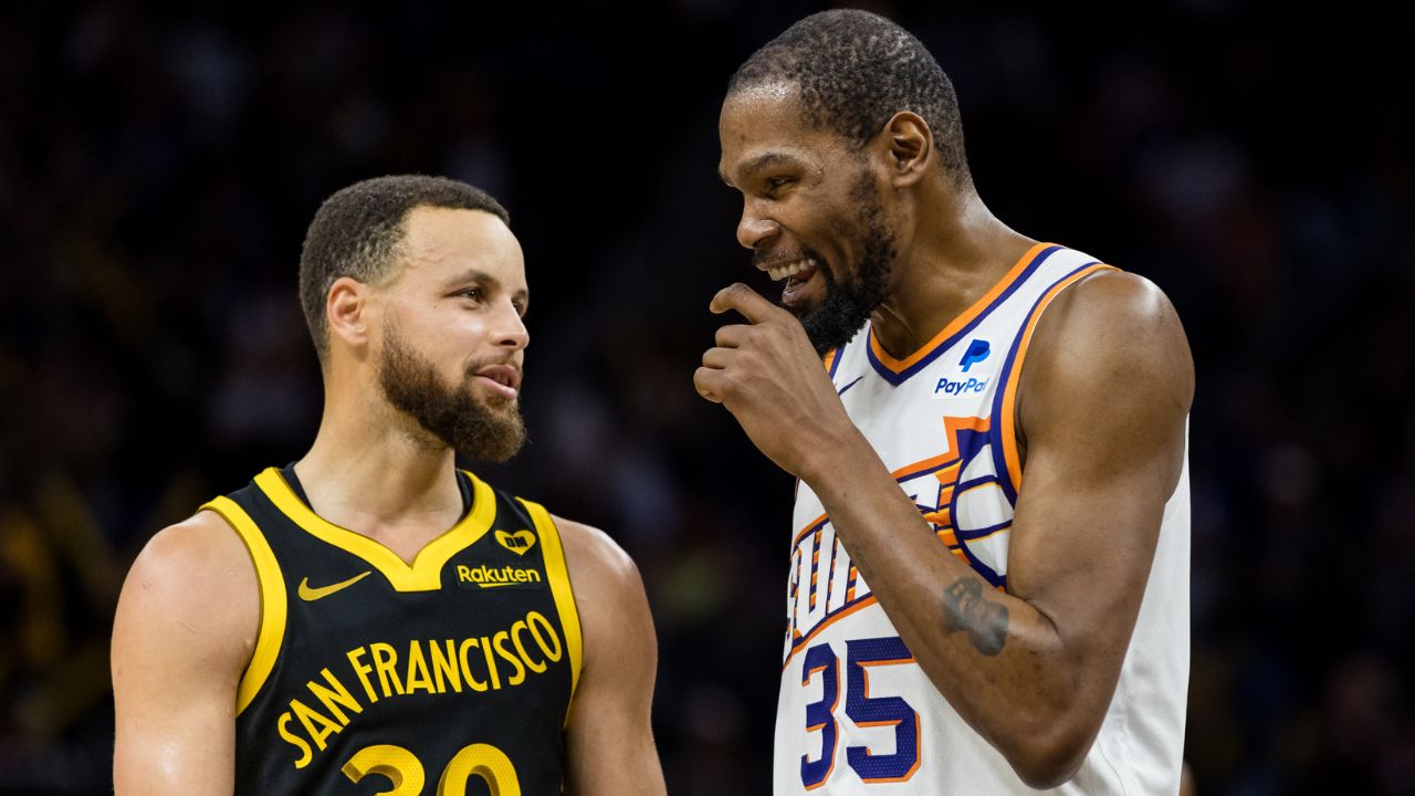 Golden State Warriors guard Stephen Curry (30) and Phoenix Suns forward Kevin Durant (35) talk during the second half at Chase Center.