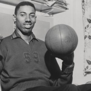 Wilt Chamberlain Smiling with Basketball Vintage 1960 s capture of Wilt Chamberlain smiling while spinning a basketball.
