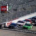 NASCAR Cup Series driver Martin Truex Jr. (19) and NASCAR Cup Series driver Kyle Busch (18) lead a restart during the NASCAR Cup Series at Dover International Speedway.