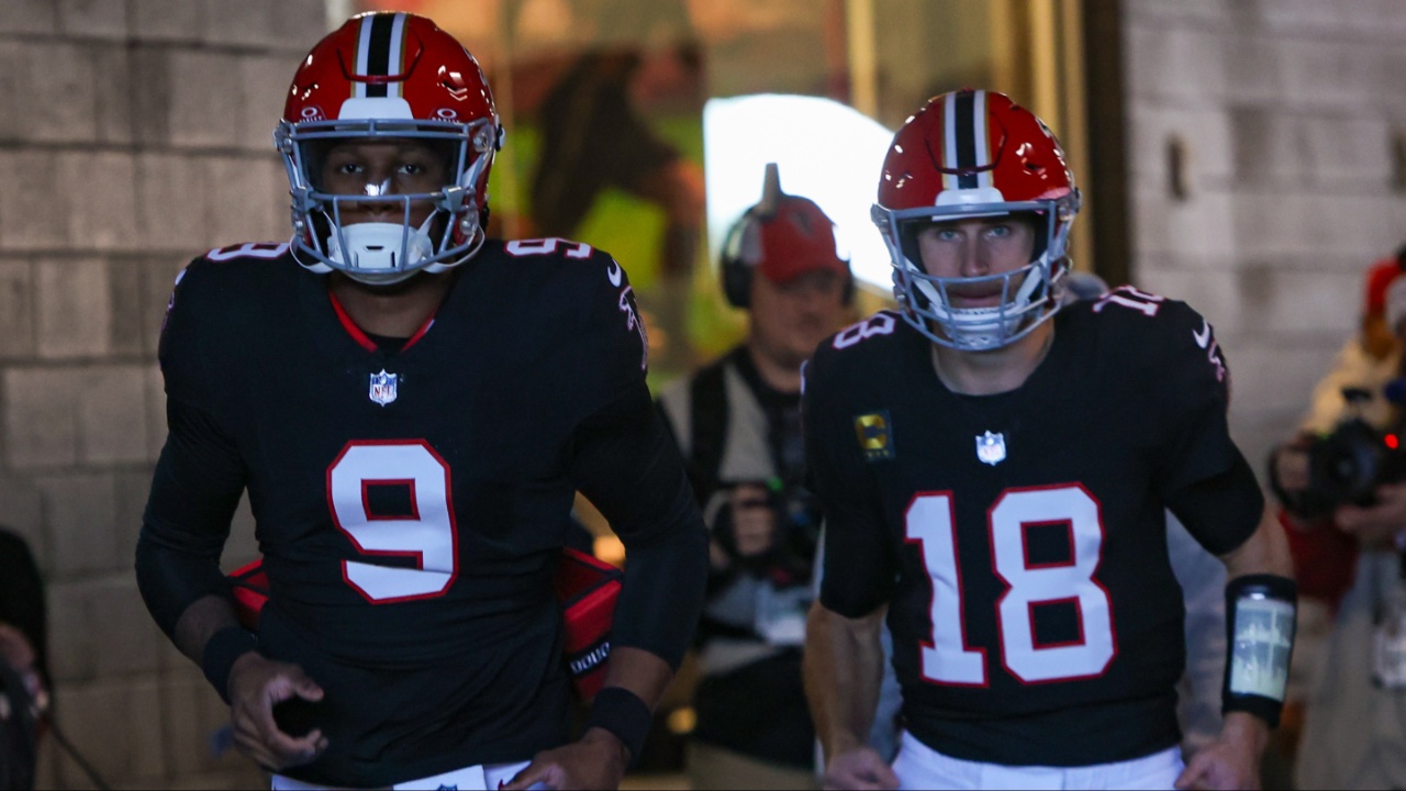 Atlanta Falcons quarterback Michael Penix Jr. (9) and quarterback Kirk Cousins (18) run on the field before a game against the New York Giants at Mercedes-Benz Stadium.