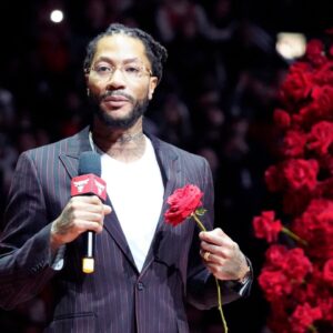 Chicago Bulls and New York Knicks former player Derrick Rose speaks as he is honored at halftime of a game between the Chicago Bulls and the New York Knicks at United Center.