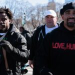 Philadelphia Eagles safety C.J. Gardner-Johnson (8) carries the Lombardi Trophy alongside quarterback Jalen Hurts (1) during the Super Bowl LIX championship parade and rally.