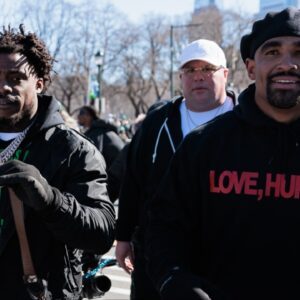 Philadelphia Eagles safety C.J. Gardner-Johnson (8) carries the Lombardi Trophy alongside quarterback Jalen Hurts (1) during the Super Bowl LIX championship parade and rally.