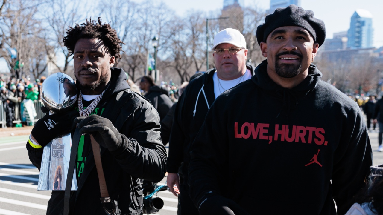 Philadelphia Eagles safety C.J. Gardner-Johnson (8) carries the Lombardi Trophy alongside quarterback Jalen Hurts (1) during the Super Bowl LIX championship parade and rally.