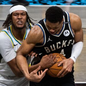 Indiana Pacers center Myles Turner (33) and Milwaukee Bucks forward Giannis Antetokounmpo (34) fight for the ball during game five of the first round for the 2024 NBA Playoffs at Gainbridge Fieldhouse.
