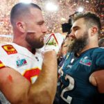 Kansas City Chiefs tight end Travis Kelce (87) talks with his brother Philadelphia Eagles center Jason Kelce (62) after he won Super Bowl LVII at State Farm Stadium.