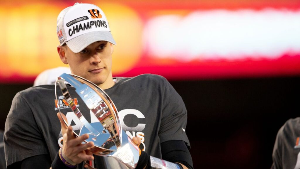 Cincinnati Bengals quarterback Joe Burrow (9) holds the AFC Championship trophy after the AFC championship NFL football game, Sunday, Jan. 30, 2022, at GEHA Field at Arrowhead Stadium in Kansas City, Mo.
