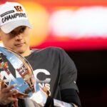 Cincinnati Bengals quarterback Joe Burrow (9) holds the AFC Championship trophy after the AFC championship NFL football game, Sunday, Jan. 30, 2022, at GEHA Field at Arrowhead Stadium in Kansas City, Mo.