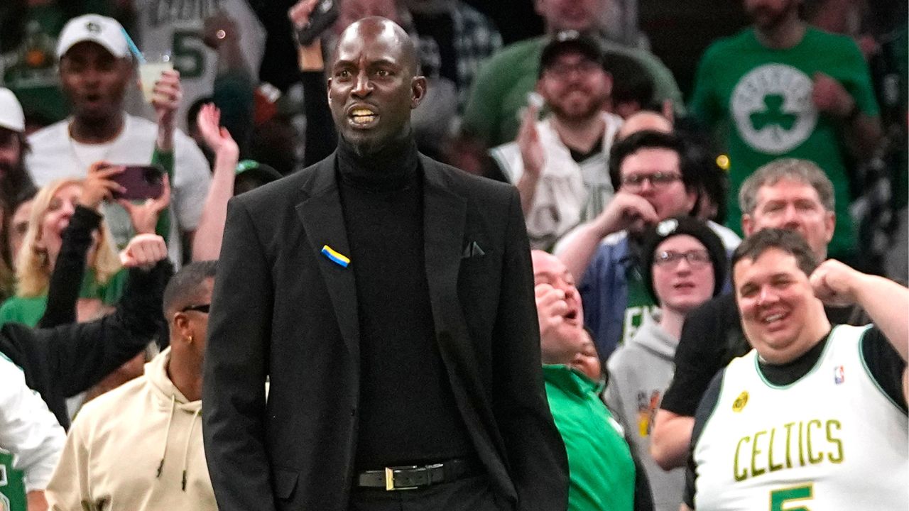 Former Boston Celtic Kevin Garnett reacts to Boston Celtics shooting guard Jaylen Brown (7) dunk (not pictured) during the first half against the Dallas Mavericks at TD Garden.