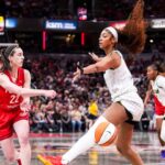 Indiana Fever guard Caitlin Clark (22) passes around Chicago Sky forward Angel Reese (5) on Saturday, May 17, 2025, during a game between the Indiana Fever and the Chicago Sky at Gainbridge Fieldhouse in Indianapolis.
