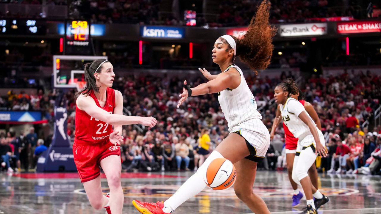 Indiana Fever guard Caitlin Clark (22) passes around Chicago Sky forward Angel Reese (5) on Saturday, May 17, 2025, during a game between the Indiana Fever and the Chicago Sky at Gainbridge Fieldhouse in Indianapolis.