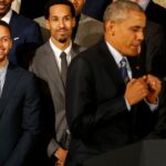 President Barack Obama (center) imitates a celebration dance of Golden State Warriors guard Stephen Curry (center) while speaking during a ceremony honoring the 2015 NBA Champion Warriors in the East Room at the White House.
