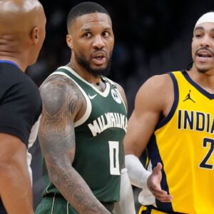 Milwaukee Bucks guard Damian Lillard (0) and Indiana Pacers guard Andrew Nembhard (2) talk with referee Marc Davis during game three of first round for the 2024 NBA Playoffs at Fiserv Forum