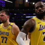 Apr 22, 2025; Los Angeles, California, USA; Los Angeles Lakers guard Luka Doncic (77) and Los Angeles Lakers forward LeBron James (23) leave a court after defeating the Minnesota Timberwolves 94-85 in game two of first round for the 2024 NBA Playoffs at Crypto.com Arena.