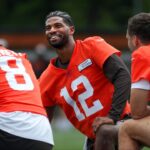 Browns quarterbacks Shedeur Sanders (12), Kenny Pickett (8) and Joe Flacco (15) talk during minicamp June 10, 2025, in Berea, Ohio.