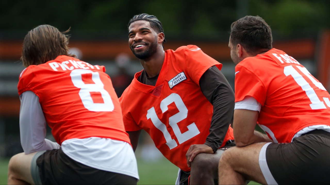 Browns quarterbacks Shedeur Sanders (12), Kenny Pickett (8) and Joe Flacco (15) talk during minicamp June 10, 2025, in Berea, Ohio.