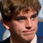 July 15, 2025; Atlanta, GA, USA; Texas quarterback Arch Manning listens to a question during SEC Media Days at the College Football Hall of Fame in Atlanta.