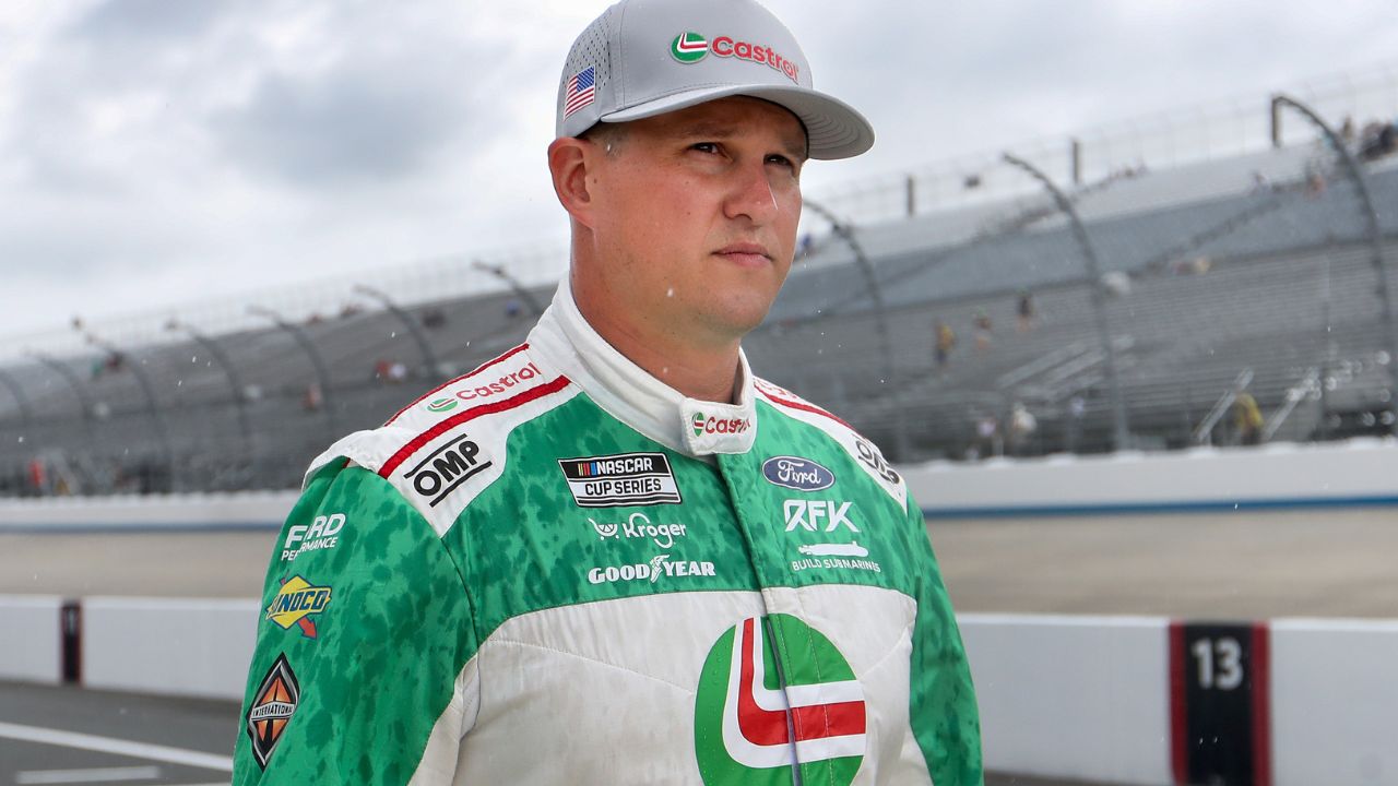 NASCAR Cup Series driver Ryan Preece walks on pit road as rain falls delaying the start of practice and qualifying for the Autotrader EchoPark Automotive 400 at Dover Motor Speedway.