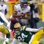 Chicago Bears wide receiver DJ Moore (2) fumbles the ball against Green Bay Packers safety Javon Bullard (20) and cornerback Carrington Valentine (24) late in the fourth quarter during their football game Sunday, January 5, 2025, at Lambeau Field in Green Bay, Wisconsin. Bullard recovered the fumble.