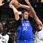 Dallas Mavericks forward Cooper Flagg (32) passes the ball against San Antonio Spurs center Nathan Mensah (31) and guard Dylan Harper (2) in the third quarter of their game at Thomas & Mack Center.