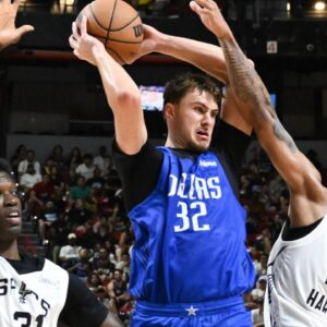Dallas Mavericks forward Cooper Flagg (32) passes the ball against San Antonio Spurs center Nathan Mensah (31) and guard Dylan Harper (2) in the third quarter of their game at Thomas & Mack Center.