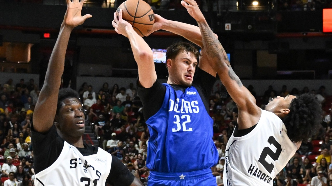 Dallas Mavericks forward Cooper Flagg (32) passes the ball against San Antonio Spurs center Nathan Mensah (31) and guard Dylan Harper (2) in the third quarter of their game at Thomas & Mack Center.
