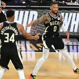 Milwaukee Bucks guard Damian Lillard (0) and forward Giannis Antetokounmpo (34) celebrate after a play during the 3rd quarter of the Emirates NBA Cup championship game against the Oklahoma City Thunder at T-Mobile Arena