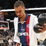 San Antonio Spurs center Victor Wembanyama (1) plays around with a ball in celebration of Fan Appreciation Day after a victory over the Toronto Raptors at Frost Bank Center.