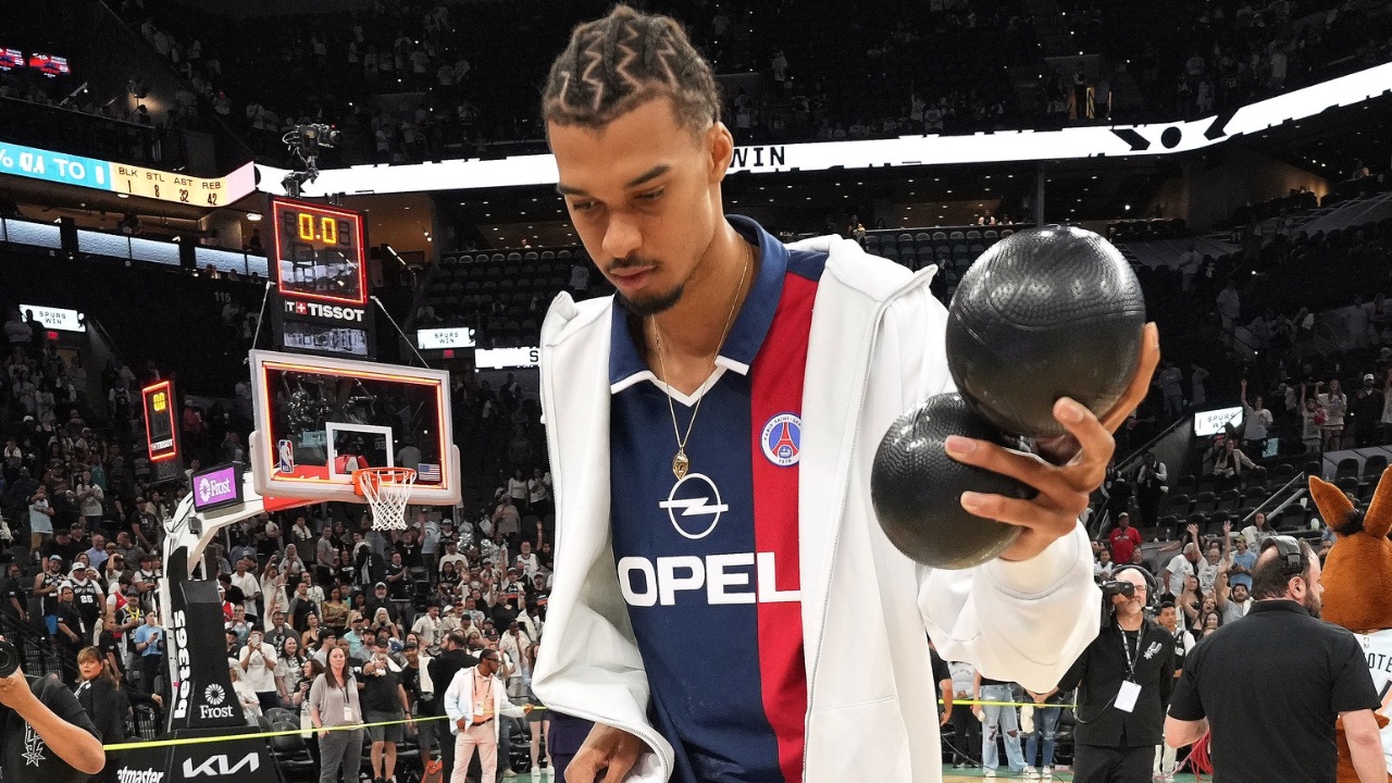San Antonio Spurs center Victor Wembanyama (1) plays around with a ball in celebration of Fan Appreciation Day after a victory over the Toronto Raptors at Frost Bank Center.
