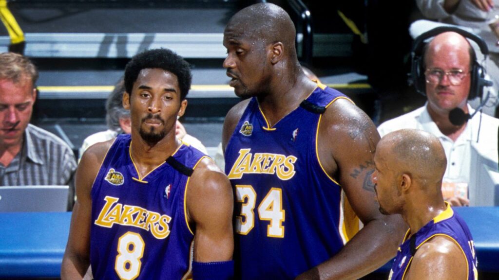 Los Angeles Lakers center Shaquille O'Neal (34) talks to guard Kobe Bryant (8) and Ron Harper (4) during a time-out against the Indiana Pacers during the 2000 NBA Finals at Canseco Fieldhouse.