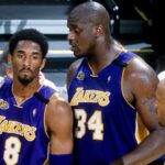 Los Angeles Lakers center Shaquille O'Neal (34) talks to guard Kobe Bryant (8) and Ron Harper (4) during a time-out against the Indiana Pacers during the 2000 NBA Finals at Canseco Fieldhouse.