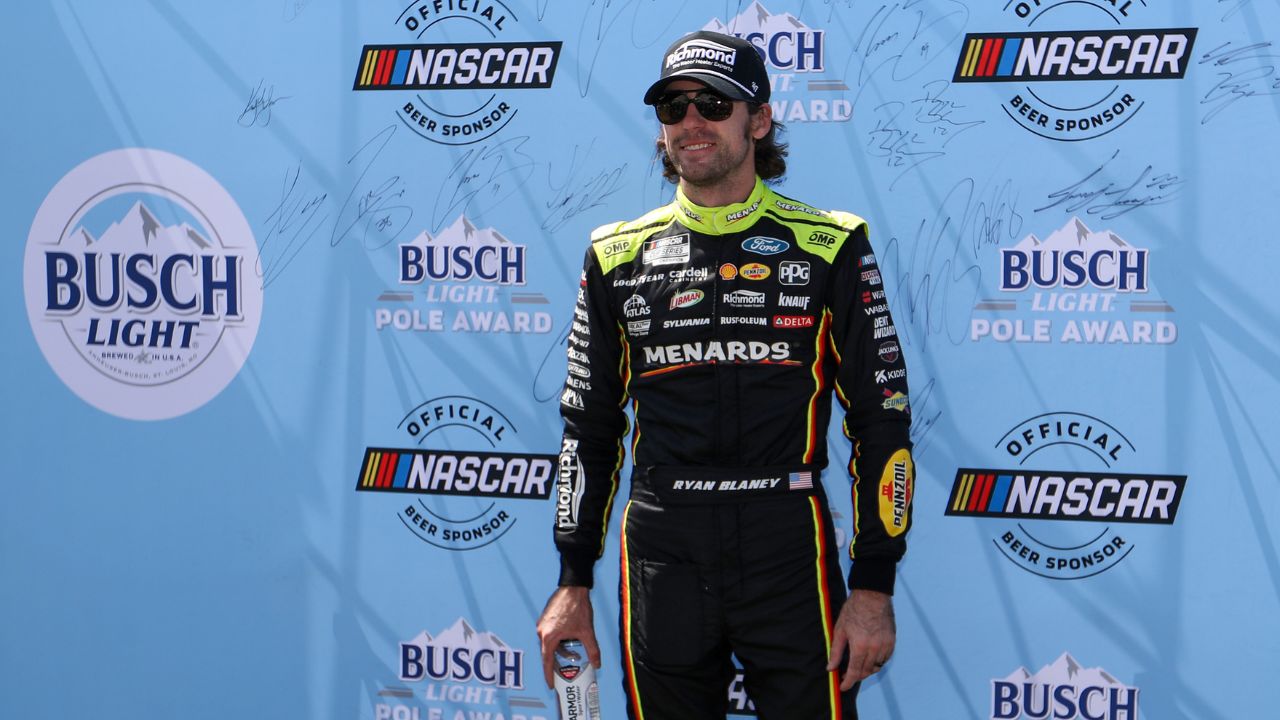 NASCAR Cup Series driver Ryan Blaney (12) stands with the Busch Light Pole Award after winning the pole for the Go Bowling at The Glen at Watkins Glen International.