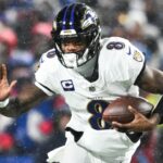 Jan 19, 2025; Orchard Park, New York, USA; Baltimore Ravens quarterback Lamar Jackson (8) runs the ball against Buffalo Bills safety Damar Hamlin (3) during the fourth quarter in a 2025 AFC divisional round game at Highmark Stadium.