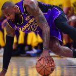 Los Angeles Lakers forward LeBron James (23) dribbles the ball against the Dallas Mavericks during the first quarter at Crypto.com Arena