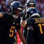 Washington Commanders wide receiver Terry McLaurin (17) and Commanders quarterback Jayden Daniels (5) celebrate after connecting on a touchdown pass against the Tennessee Titans during the first quarter at Northwest Stadium.