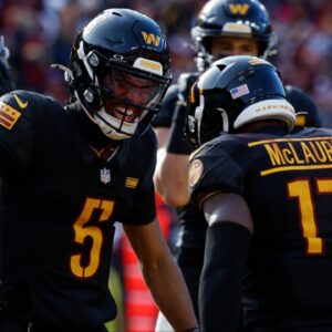 Washington Commanders wide receiver Terry McLaurin (17) and Commanders quarterback Jayden Daniels (5) celebrate after connecting on a touchdown pass against the Tennessee Titans during the first quarter at Northwest Stadium.