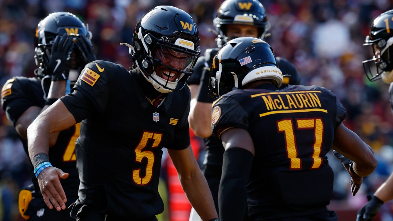 Washington Commanders wide receiver Terry McLaurin (17) and Commanders quarterback Jayden Daniels (5) celebrate after connecting on a touchdown pass against the Tennessee Titans during the first quarter at Northwest Stadium.