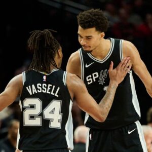 San Antonio Spurs guard Devin Vassell (24) and center Victor Wembanyama (1) celebrate during the second half in a game against the Portland Trail Blazers at Moda Center.