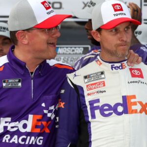 NASCAR Cup Series driver Denny Hamlin (right) is congratulated by crew chief Chris Gabehart (left) in victory lane after winning the M&M's Fan Appreciation 400 at Pocono Raceway.