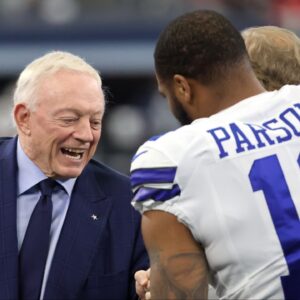Dallas Cowboys owner Jerry Jones meets with outside linebacker Micah Parsons (11) prior to the NFC Wild Card playoff football game against the San Francisco 49ers at AT&T Stadium.