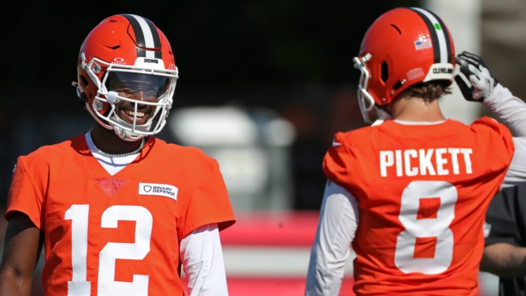 Cleveland Browns quarterback Shedeur Sanders (12) shares a laugh with quarterback Kenny Pickett (8) during NFL training camp practice at the Cleveland Browns training facility, Wednesday, July 23, 2025, in Berea, Ohio.