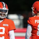 Cleveland Browns quarterback Shedeur Sanders (12) shares a laugh with quarterback Kenny Pickett (8) during NFL training camp practice at the Cleveland Browns training facility, Wednesday, July 23, 2025, in Berea, Ohio.