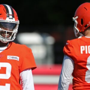 Cleveland Browns quarterback Shedeur Sanders (12) shares a laugh with quarterback Kenny Pickett (8) during NFL training camp practice at the Cleveland Browns training facility, Wednesday, July 23, 2025, in Berea, Ohio.
